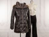 a mannequin and a leather jacket on a mannequin stand