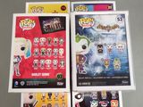 a bunch of pop vinyl figures on display in a box