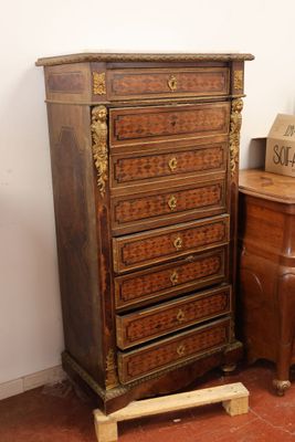 a small chest of drawers next to a small table