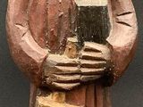 figurine of a woman holding a book and a book