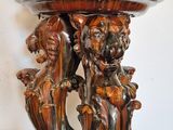 a large wooden vase with a bird on top of it