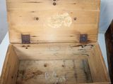 a small wooden box with writing on the inside