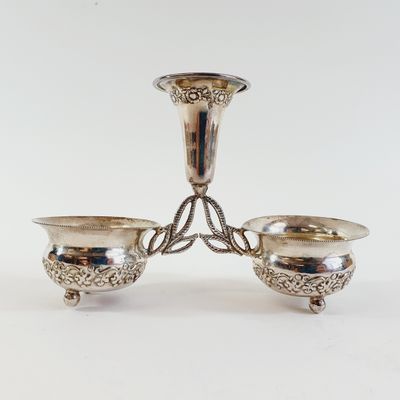 pair of silver plated candlesticks on a stand
