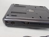 a laptop with a cord attached to it on a table