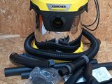 a yellow and black vacuum sitting on a wooden floor