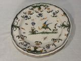 a plate with a bird on it on a table