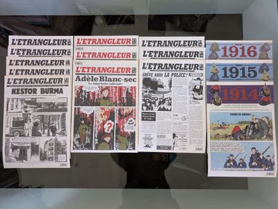 a lot of newspapers on display in a glass case