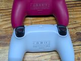 two game controllers are sitting side by side on a wooden floor