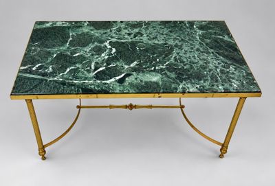 a green marble top coffee table with brass legs
