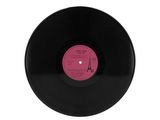 a black vinyl record with a pink label on it