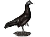statue of a black bird on a white background with a reflection