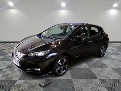 the nissan versa sedan is parked in a clean room