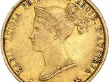 a close up of a gold coin with a woman ' s head on it