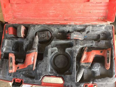 a red tool case with tools in it on the floor