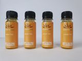 three bottles of honey syrup sit on a white surface