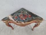 a small table that has a painting on it