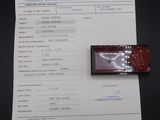 a picture of a certificate and a stamp on a table