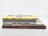three books stacked on top of each other on a white surface
