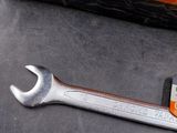 a wrenet that is laying on the floor next to a bag