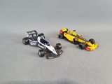 two toy cars that are sitting next to each other