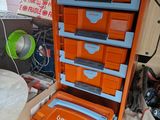a large orange and blue storage unit with many drawers