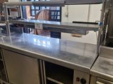 stainless steel counter top in a commercial kitchen with stainless steel appliances