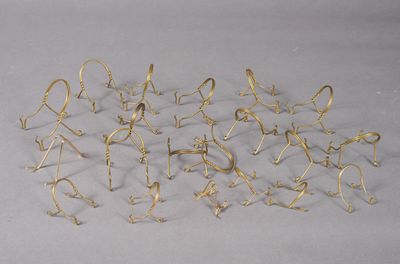 a lot of gold colored metal objects on a white surface