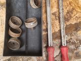two wrenches and a pair of pliers on the floor