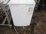 an image of a white refrigerator in a yard