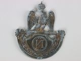 a metal plaque with a bird on top of it