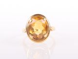 a close up of a ring with a large citrine stone in it