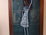 a stained glass window with a picture of a woman holding an orange