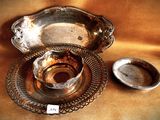 a silver plate and a silver bowl on a table