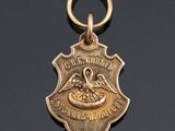 an image of a gold medal with a bird on it
