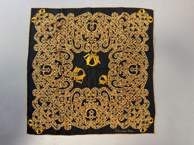 a close up of a black and gold scarf with a horse on it