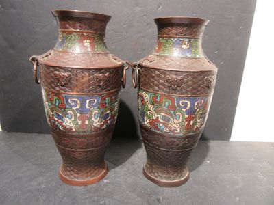 two vases that are sitting next to each other on a table