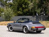 a silver porsche parked on the side of the road