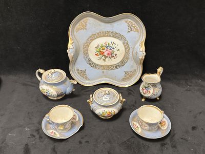 une image représentant une table avec un plateau, des tasses et des soucoupes