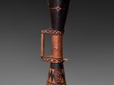 a close up of a wooden vase with a design on it