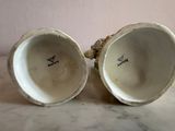 two cups that are sitting on a table