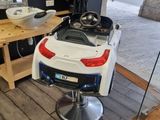 une voiture blanche garée sur un fauteuil de coiffeur