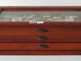 an old wooden jewelry box with glass top and drawers