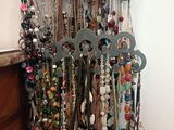 a picture of a rack of necklaces hanging on a wall