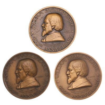 three bronze medallions depicting two men and a woman on a white background