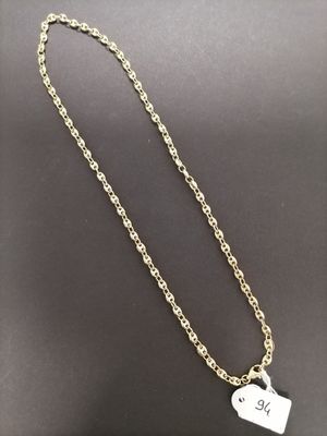 a gold chain with a small heart charm on it
