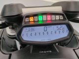 a close up of a digital clock on a motorcycle