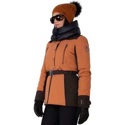woman wearing a brown jacket and black pants with a brown hat and scarf