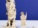 two figurines of a woman and a child on a table