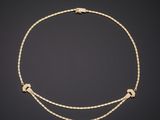 a gold and diamond necklace, by business