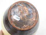 a close up of a brown vase with a label on it